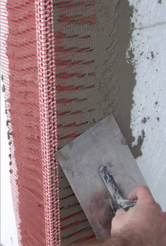 Material in action.

Here you can see the corner bead being laid into render and set plumb, prior to applying the main EWI render system.